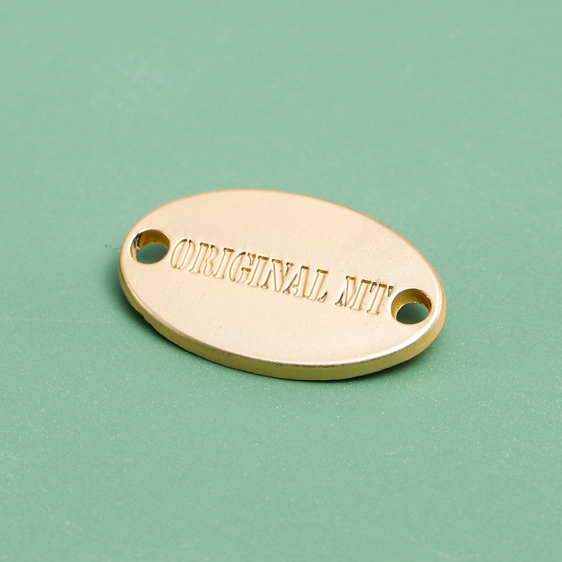 Polished gold custom oval metal label with mounting holes